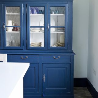 blue dresser with white wall