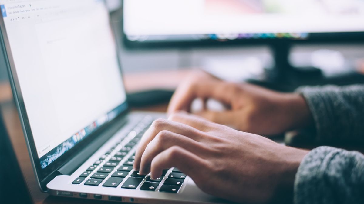 person typing on laptop