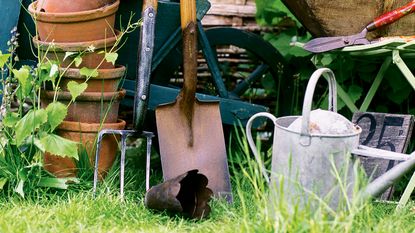 Garden tools including hoe, spade, pots and watering can