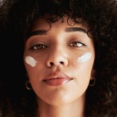 best night cream - A portrait of a young Black woman wearing a night cream on her skin