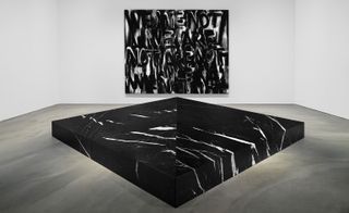 Black slab of marble on the floor in a gallery