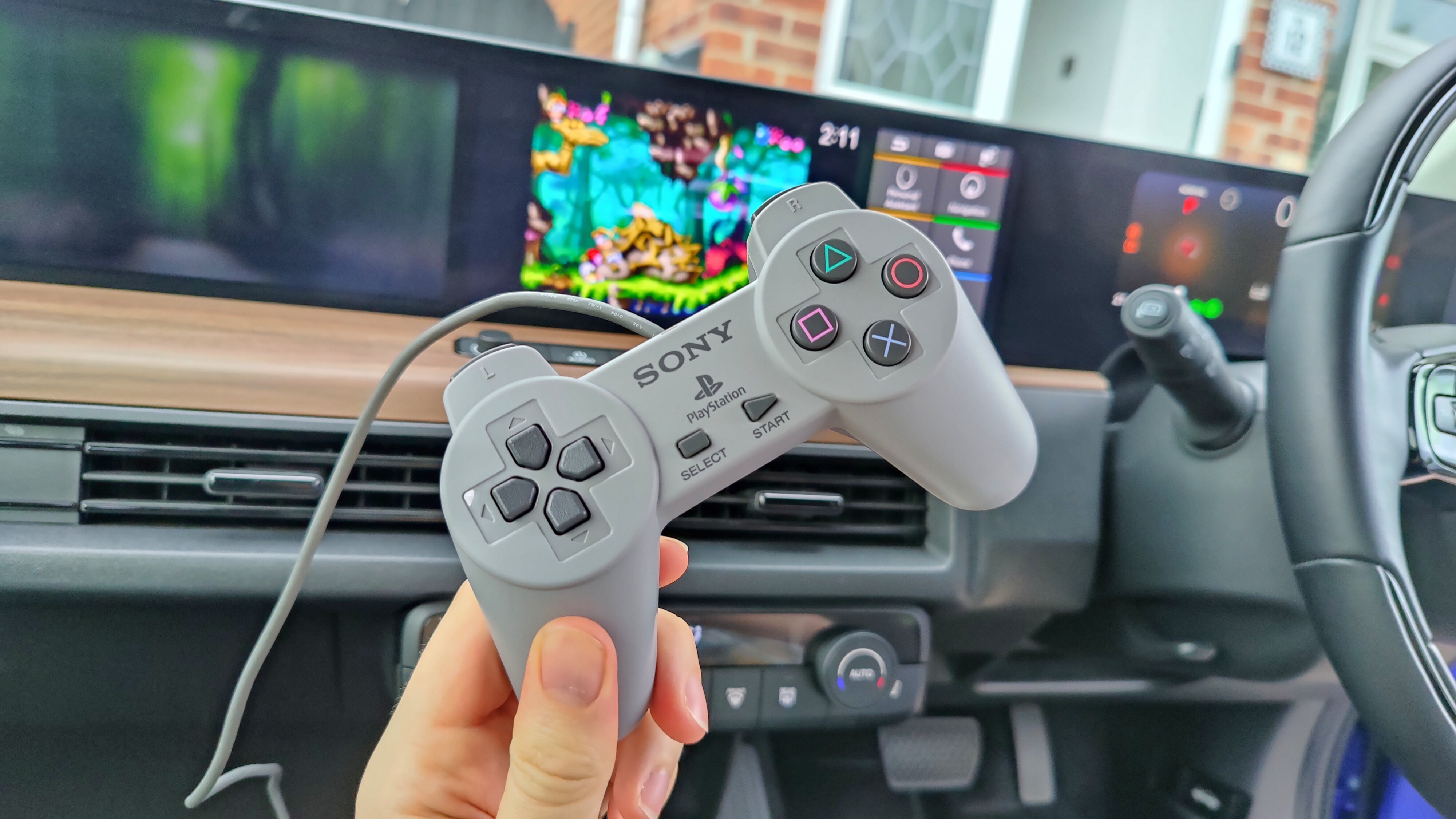 PlayStation Classic controller in front of 10-inch screen playing Rayman