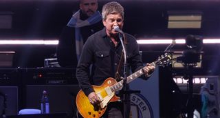 Noel Gallagher performs live with Oasis and plays a Gibson Les Paul Standard