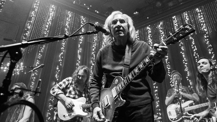 Joe Walsh playing guitar on stage with the band The War on Drugs