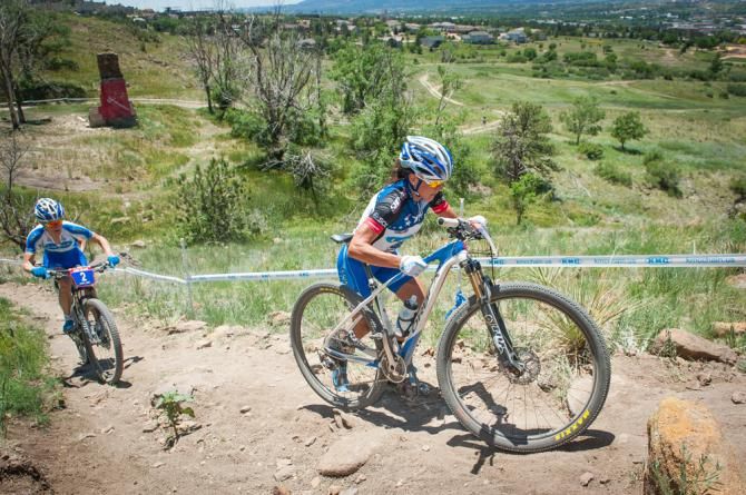 Katerina Nash (Luna) and Georgia Gould (Luna) make their way up a tricky ascent on the back side of the course during the elite women's cross country race. Most of the women ended up dismounting and running the bike up the final section of the climb.