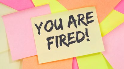 Sticky note on top of a scattered sticky notes that says You Are Fired.