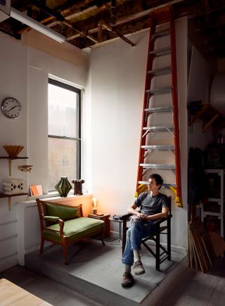 Devin Wilde sitting in his New York studio