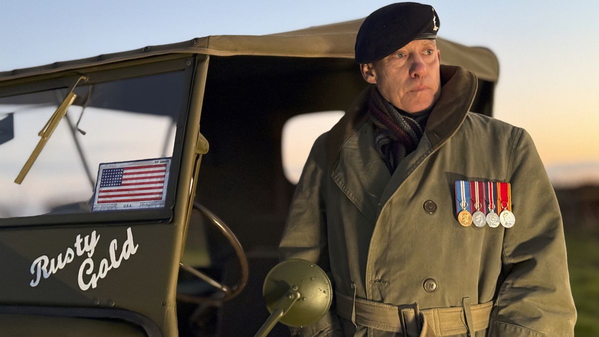 A man standing next to an old army jeep lit by the Harlowe Blade 5 &amp; 10 LED Lighting Kit