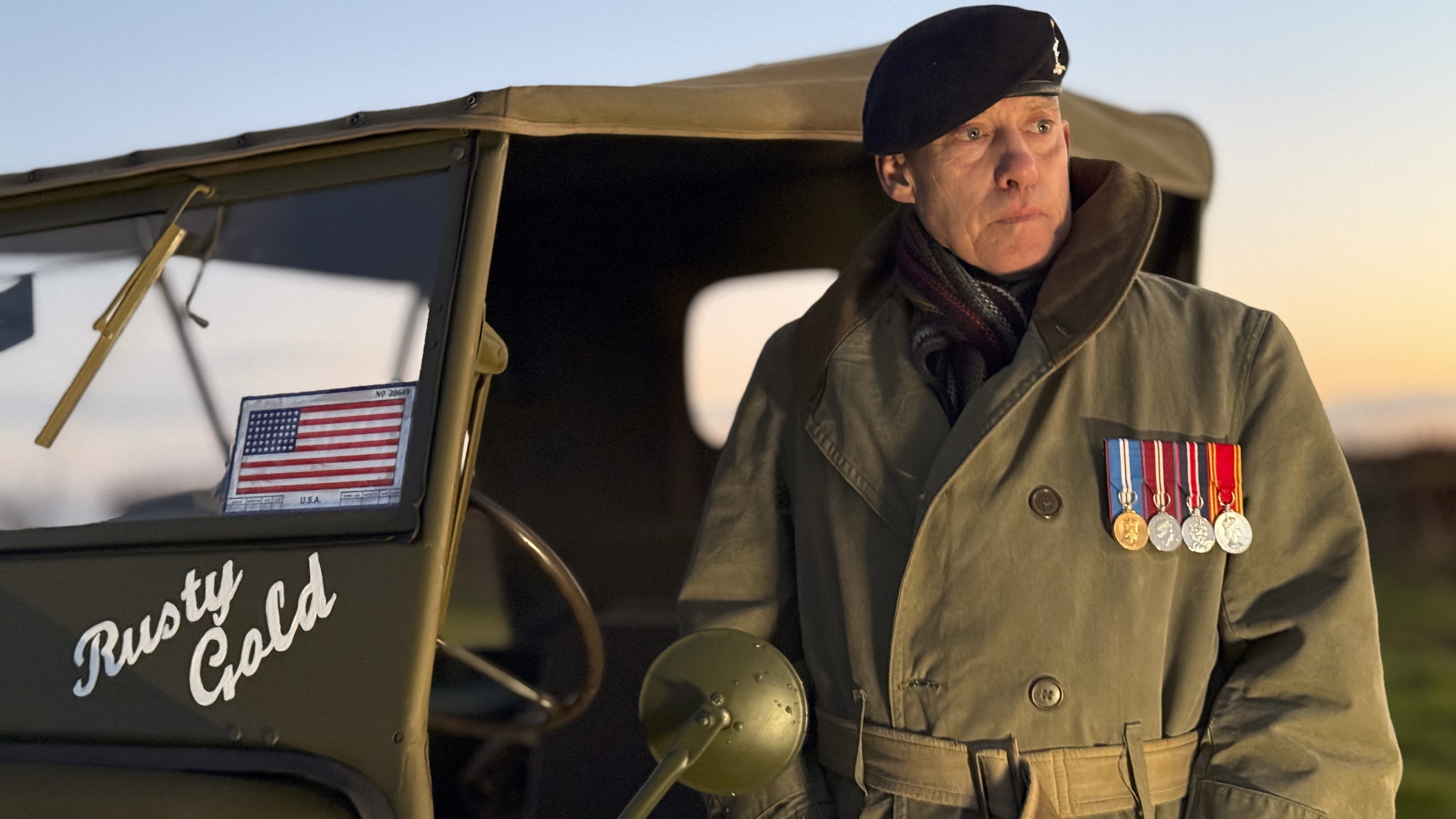 A man standing next to an old army jeep lit by the Harlowe Blade 5 & 10 LED Lighting Kit