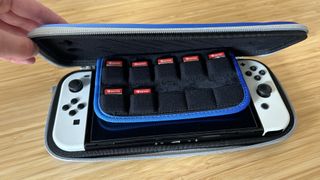 TomToc Nintendo Switch case being closed on a wooden table