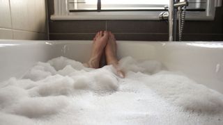 View of feet in a bubble bath