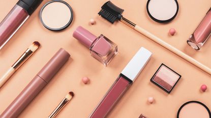 makeup products on a beige background