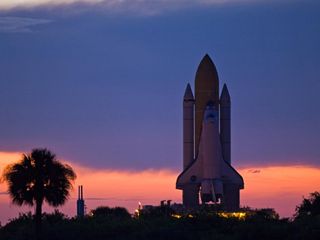 Space shuttle Discovery is silhouetted against the dawn sky as it rolls out to Launch Pad 39A at NASA's Kennedy Space Center in Florida before launch on mission STS-128 to the International Space Station. After a two-hour delay due to lightning in the ar