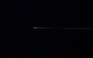 The return capsule of Japan's Hayabusa2 asteroid-sampling mission streaks through Earth's atmosphere shortly before landing on Dec. 5, 2020.