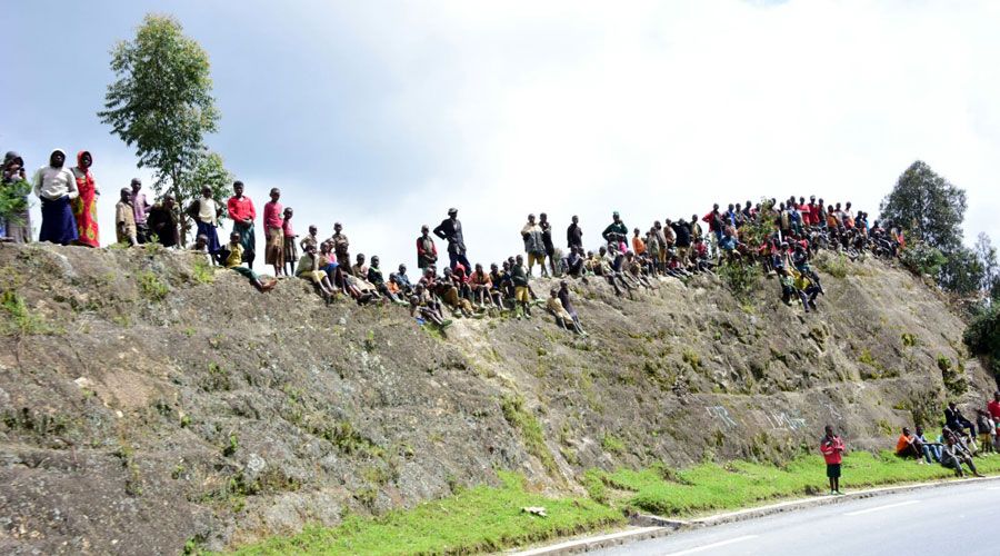 The fans cheer from the side of the road