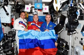 NASA accused Russia of staging an anti-Ukrainian propaganda photo on the ISS after Russia’s space agency posted this photo of three cosmonauts holding a flag of the Luhansk People's Republic.