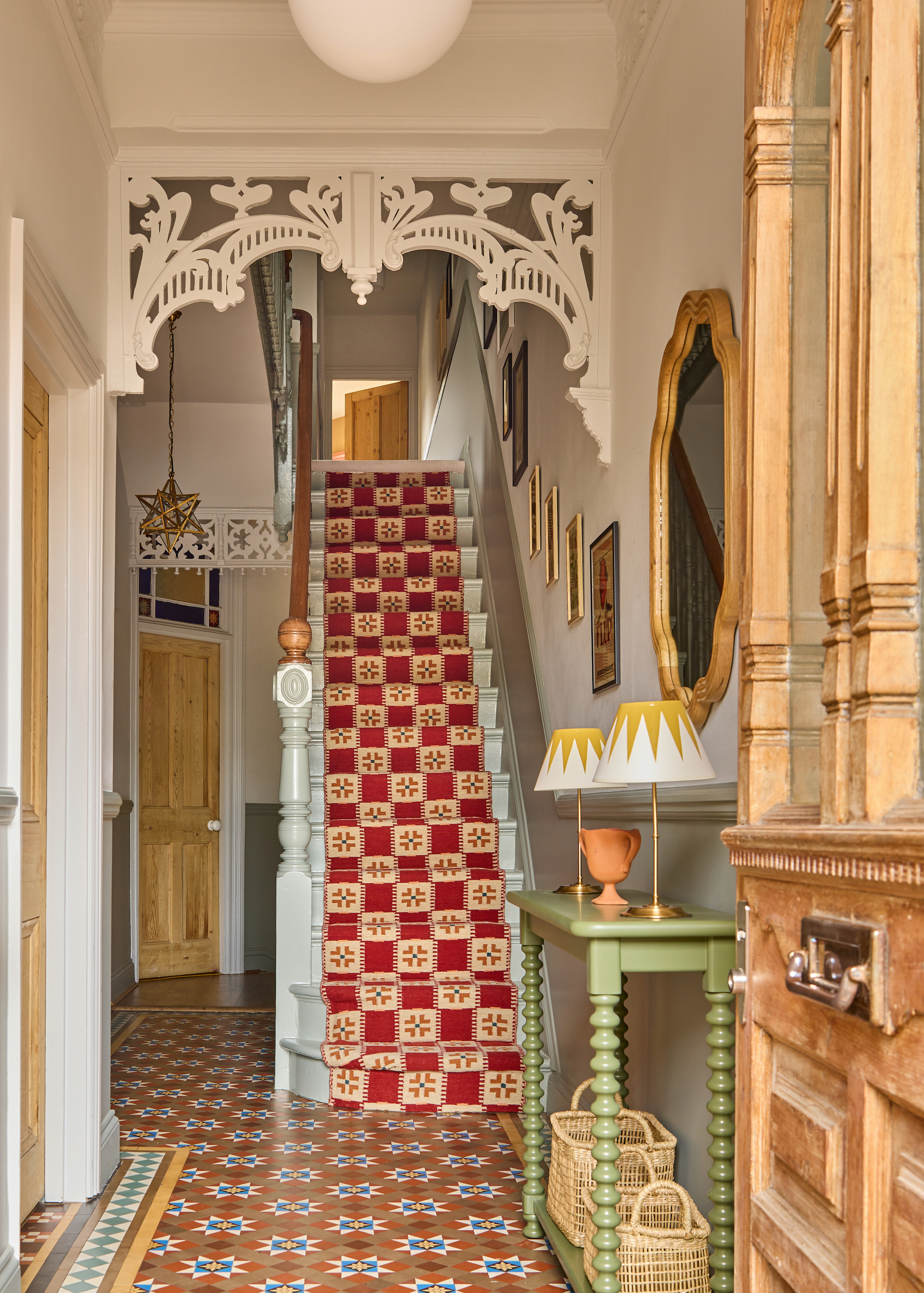 staircase with patterned runner in red and cream