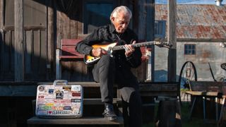 Musselwhite strums his Harmony Bobkat in front of Clarksdale’s Shack Up Inn