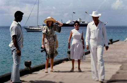 Princess Margaret, Colin Tennant, Lord Glenconner and Anne Tennant, Lady Glenconner wait on the jetty for Queen Elizabeth ll and Prince Philip's arrival to Mustique on Britannia in1977 in Mustique. (Photo Anwar Hussein/Getty Images).