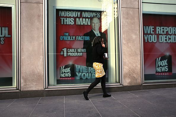 A woman walks by an ad for Bill O&amp;#039;Reilly&amp;#039;s television show.