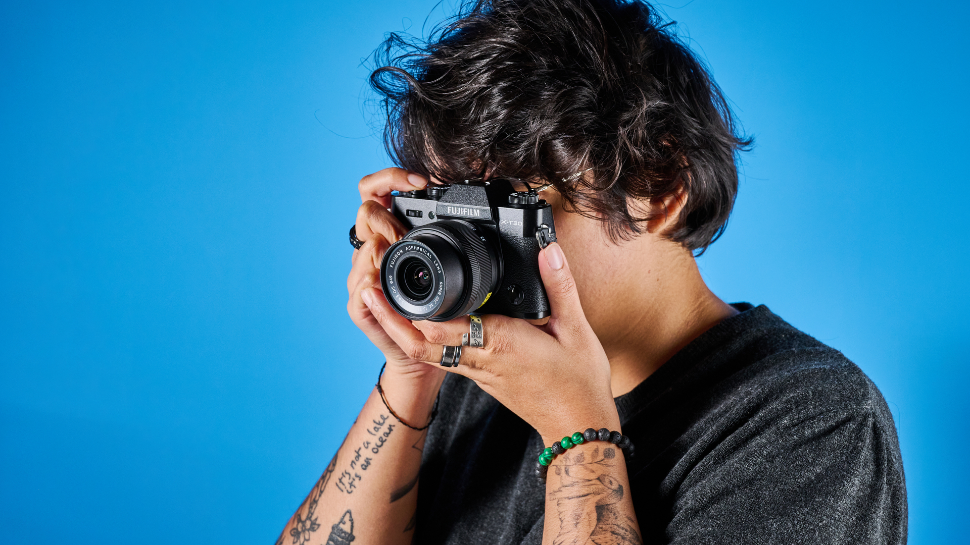 The Fujifilm X-T30 III in hand being used to shoot through the EVF