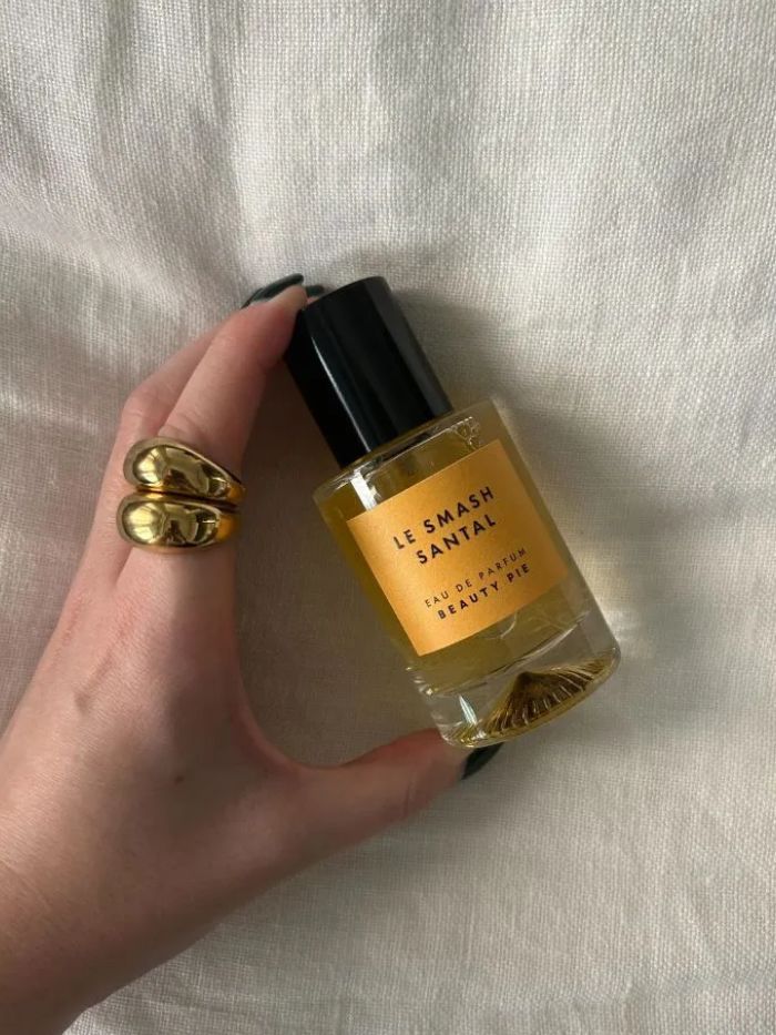 The Beauty Pie Le Smash Santal perfume on a white linen background