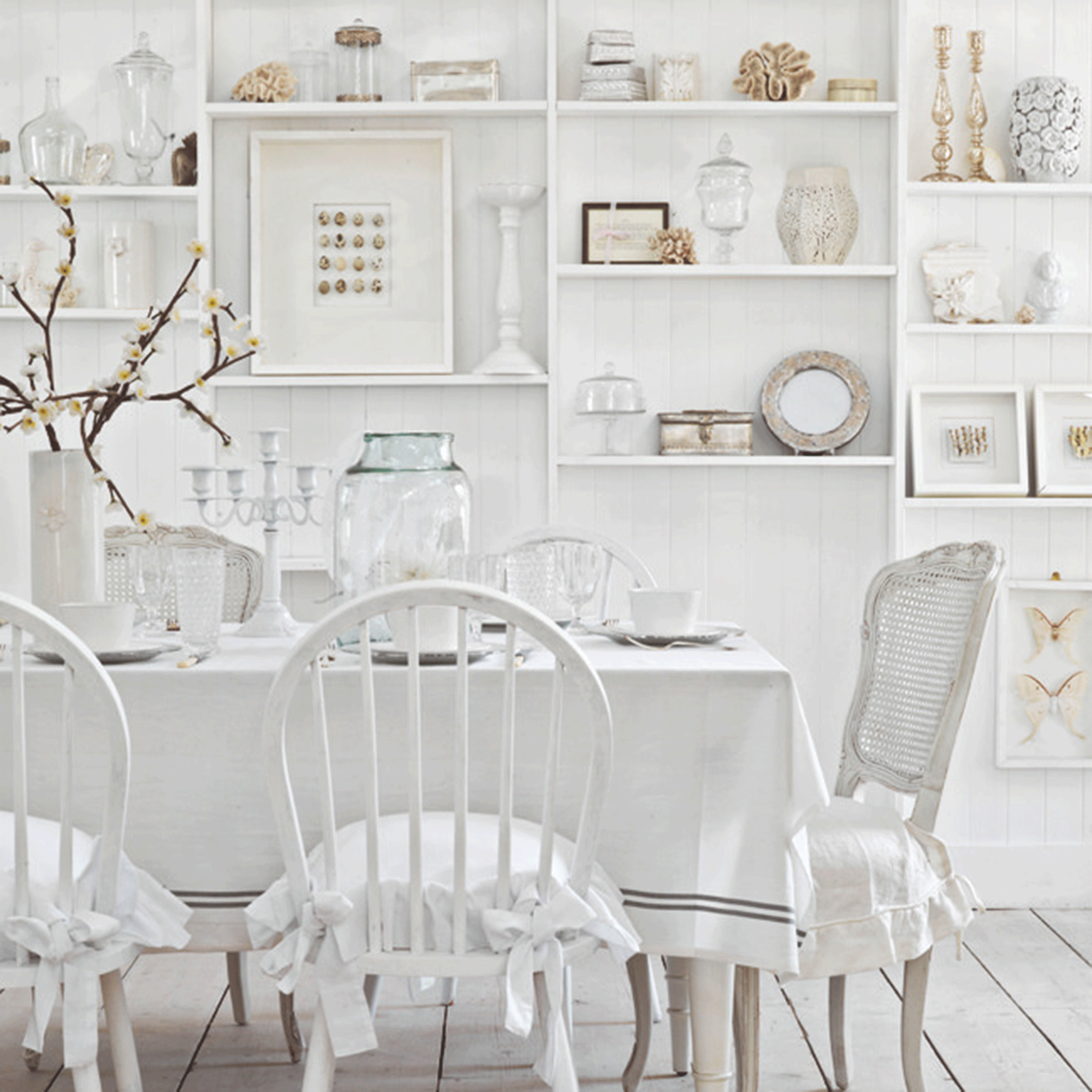White dining room with white table and chairs