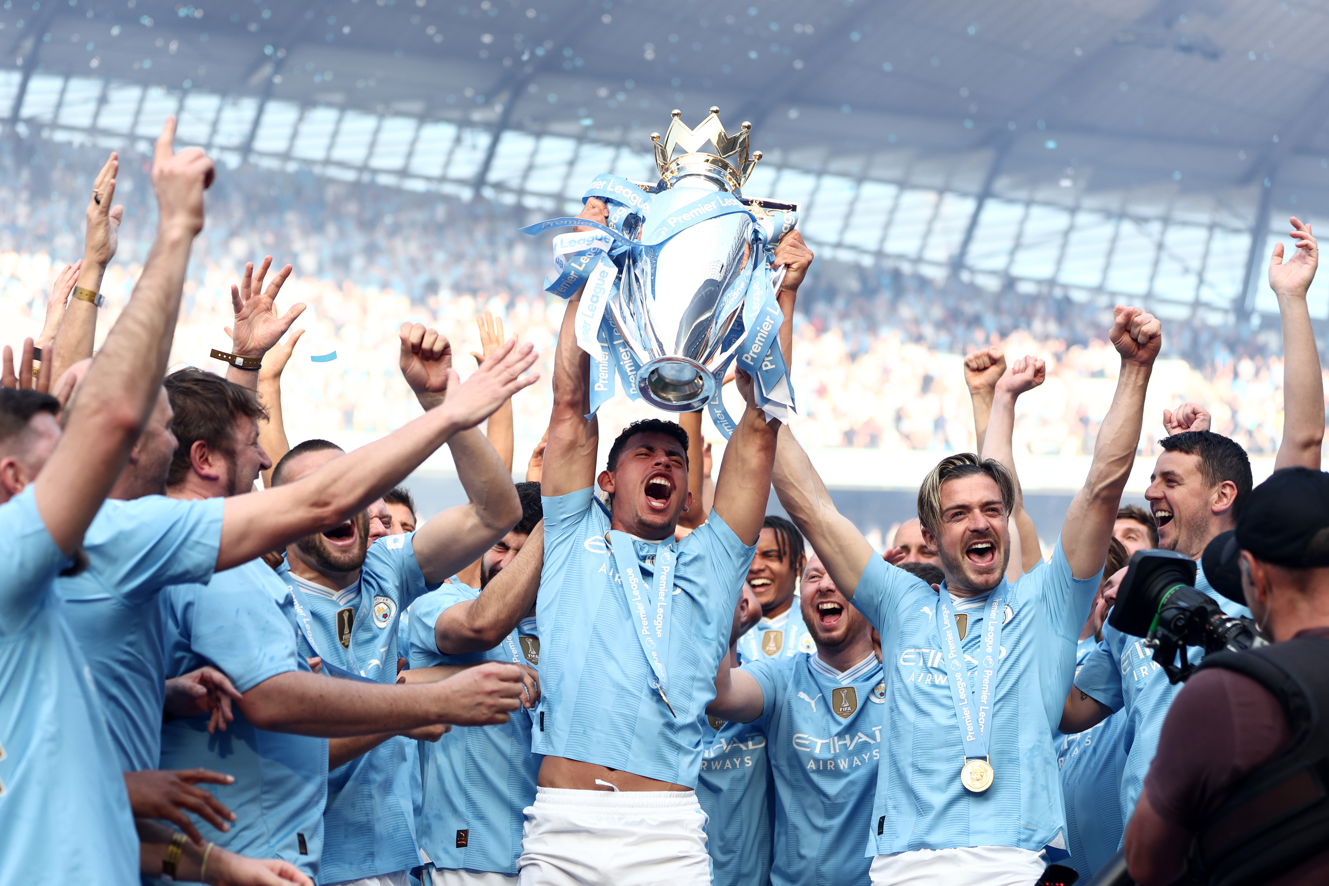 Manchester City players celebrate winning a fourth Premier League title in a row in May 2024.