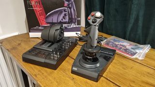 The Hori HOTAS Flightstick and throttle control, displayed in front of the box on a desk