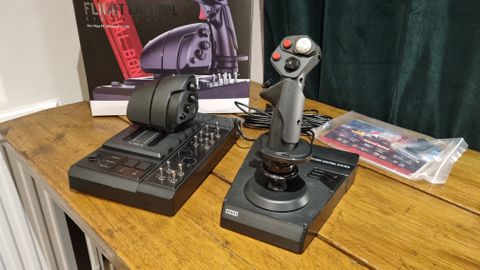 The Hori HOTAS Flightstick and throttle control, displayed in front of the box on a desk