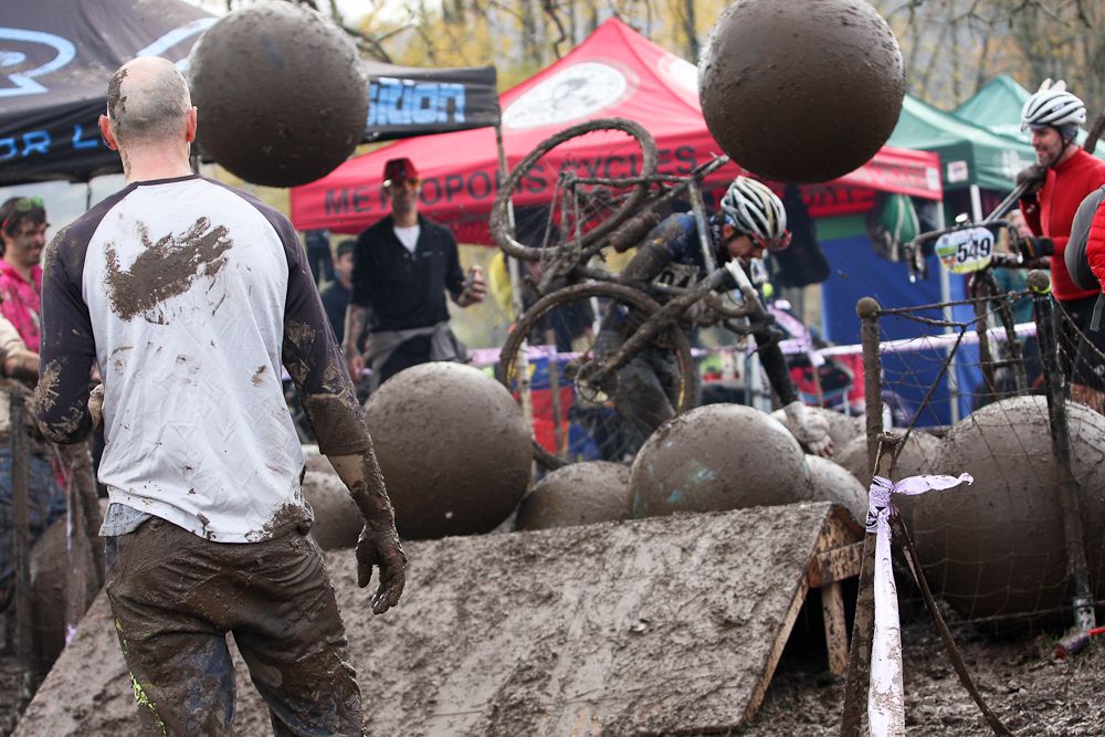 Riders try to make their way through the pit of yoga balls while spectators take aim.