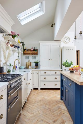 white shaker style kitchen with blue island