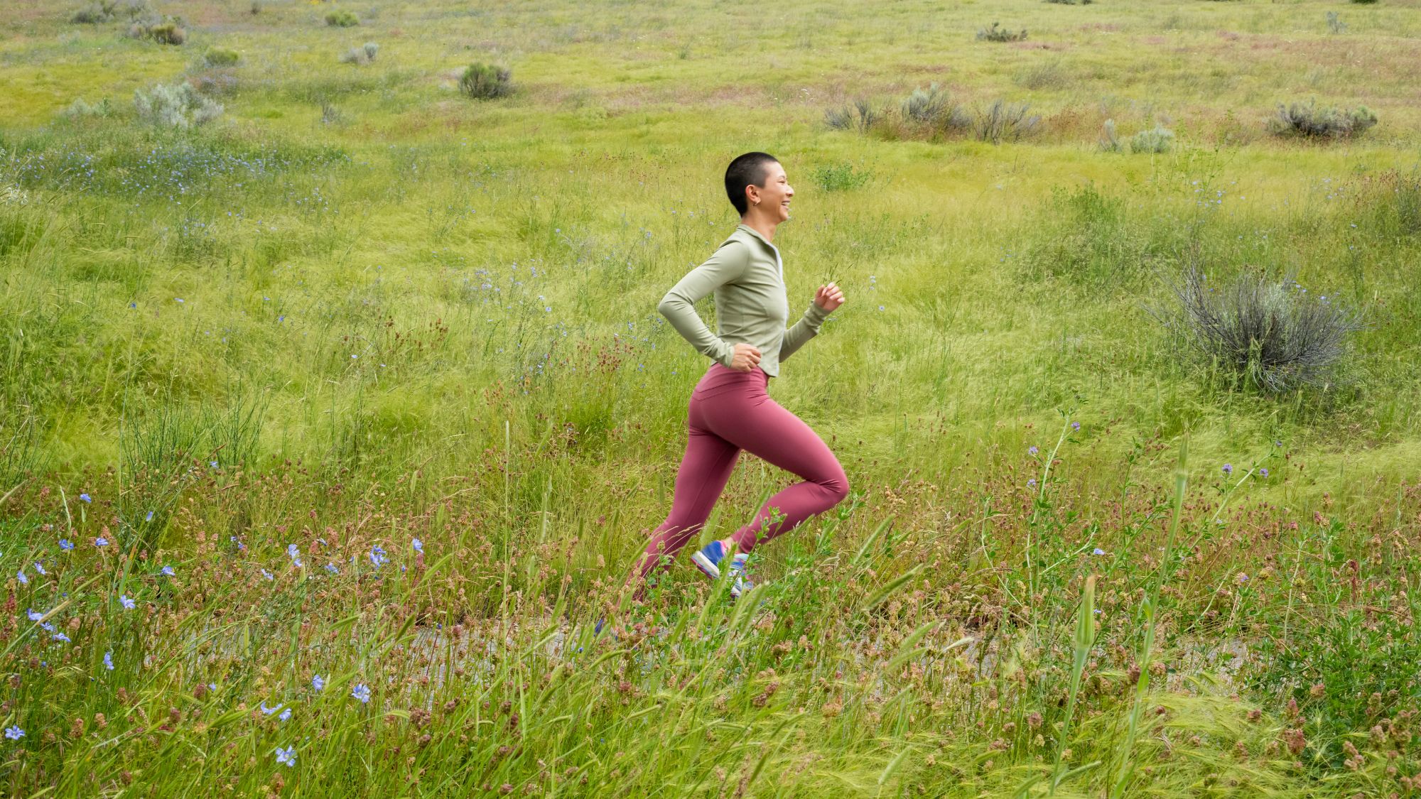 A woman running in a wildflower meadow