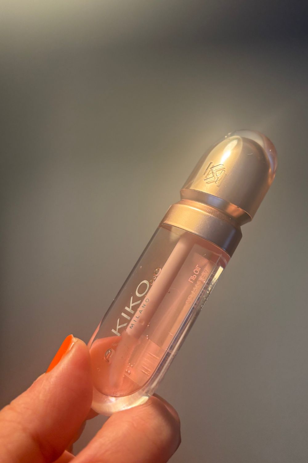 a hand holding kiko milano lip oil