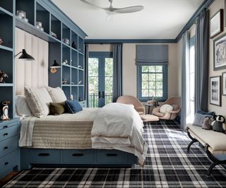 teenage bedroom with storage shelves and bed with drawers with plaid carpet