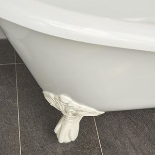 bathroom with grey floor and ornate feet white bathtub