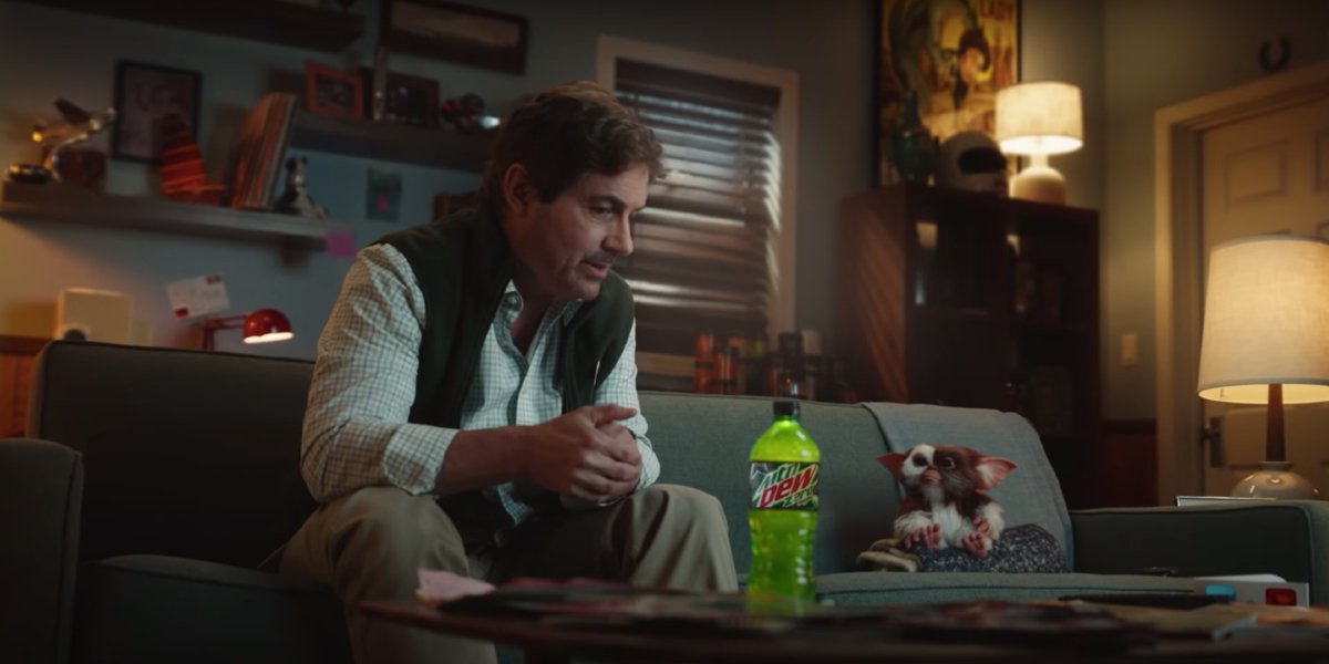 Gremlins Mountain Dew ad Zach Galligan and Gizmo sit on the couch