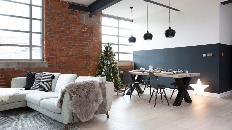 living area with brick wall and white sofa 