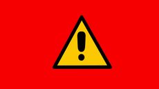 Yellow caution sign against a red background. 