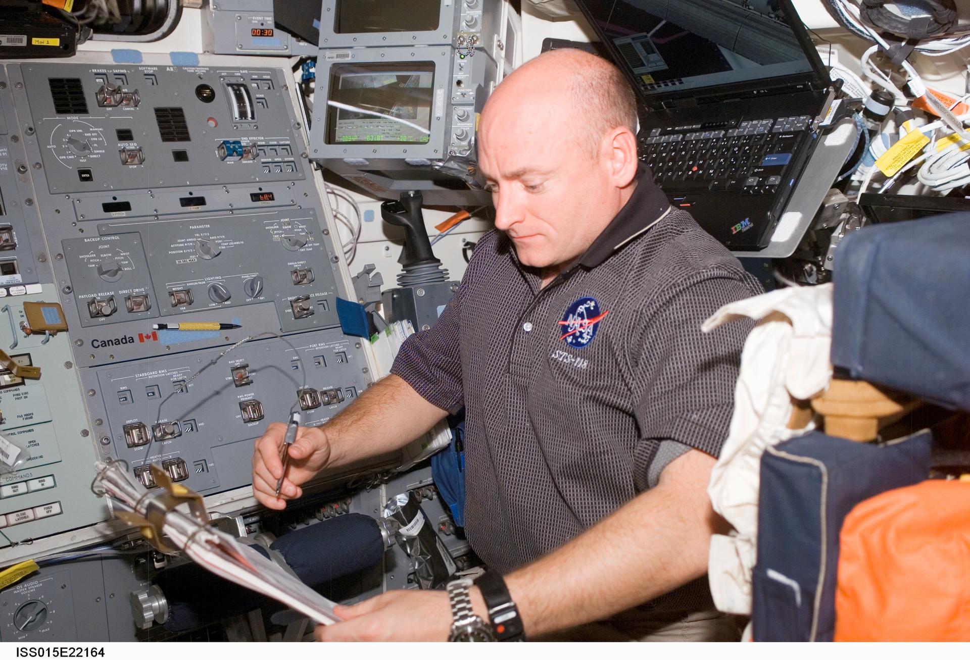 a man looks at a checklist in a cramped cockpit