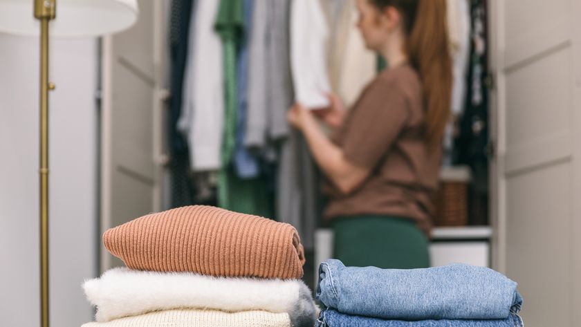 Woman sorting out clothing in closet