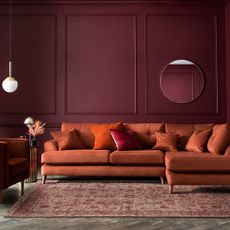 Red sofa in purple room 