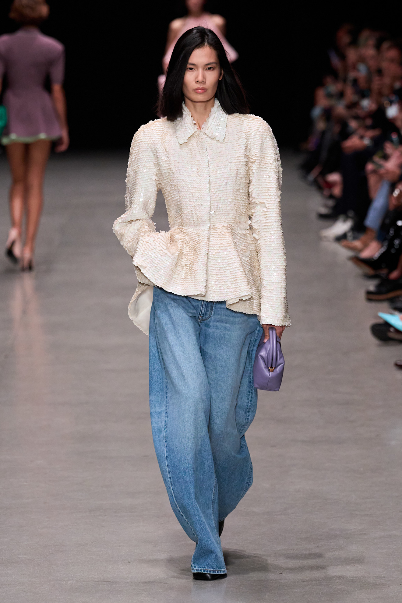 Model wears puddle jeans a pointed-toe boots on the Stella McCartney SS26 runway.