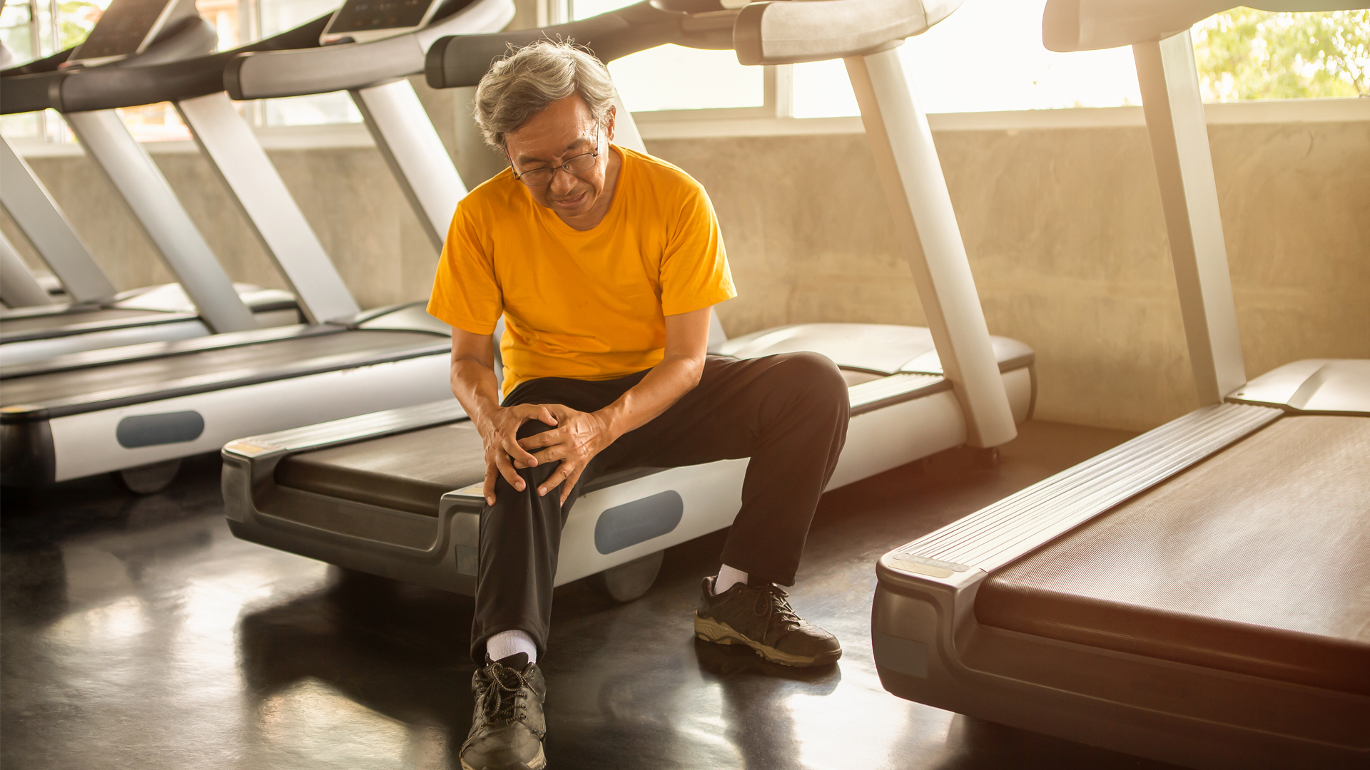 Image of man nursing knee in recovery from injury