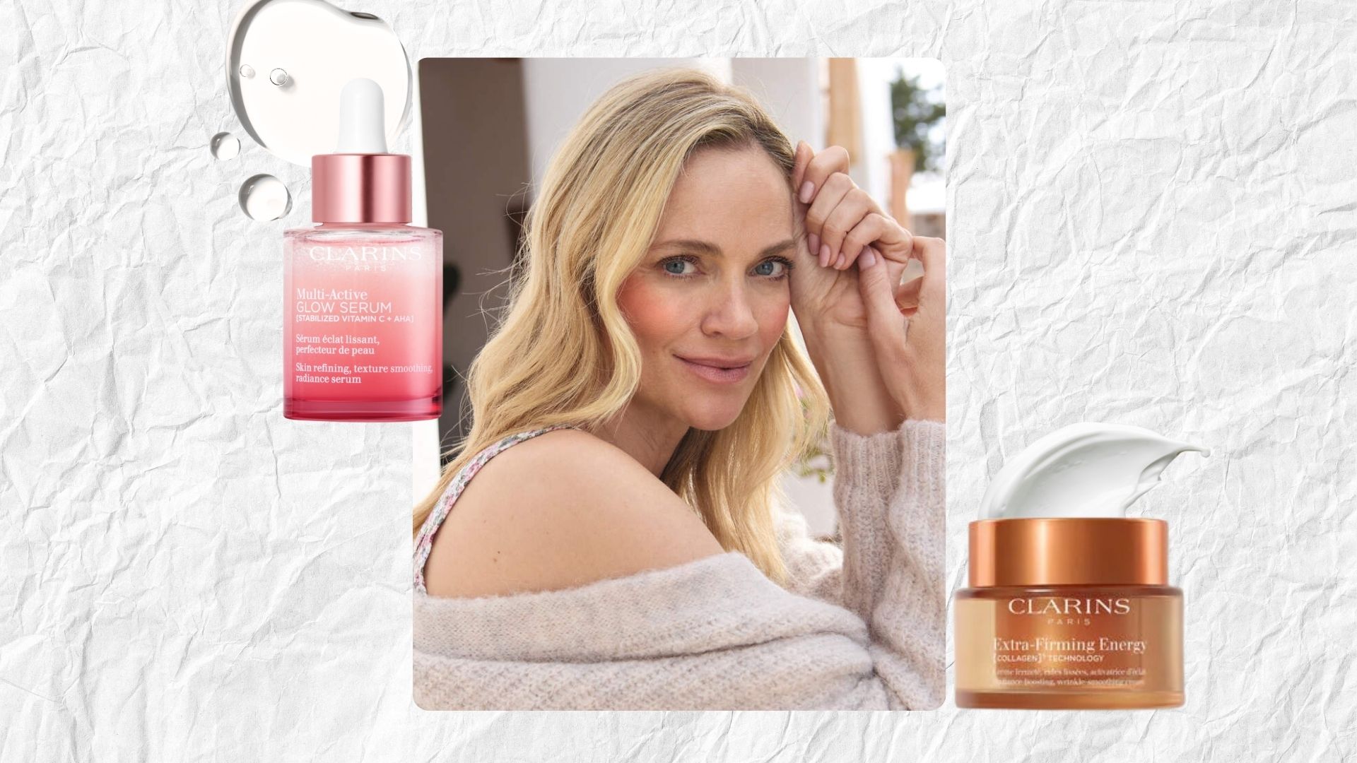 A woman with blonde hair and great skin wearing a cashmere cardigan next to clarins moisturiser and serum