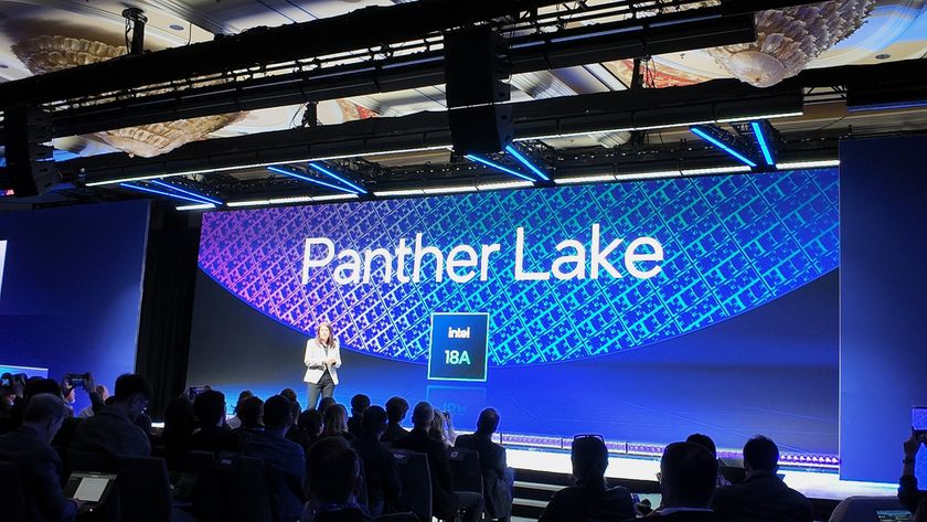 A photograph of Intel&#039;s Interim Co-CEO Michelle Johnston Holthaus standing on stage, with a background displaying Panther Lake and Intel 18A