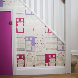staircase panel in hallway with pink wallpaper