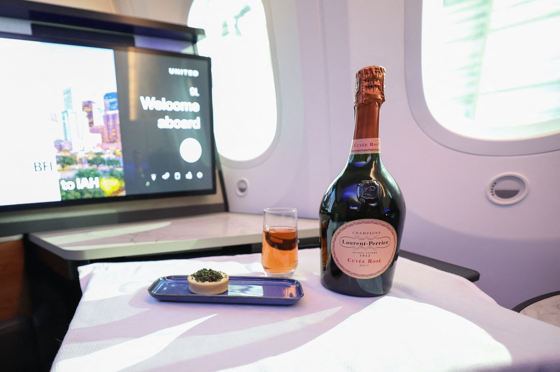 A bottle of Laurent-Perrier rosé Champagne served with caviar in United Airline's new Dreamliners with Elevated Interiors and Studio Polaris seats