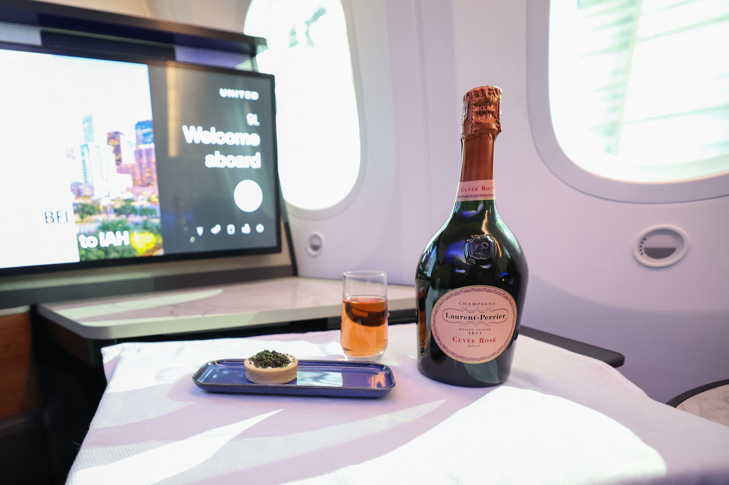 A bottle of Laurent-Perrier ros&amp;eacute; Champagne served with caviar in United Airline's new Dreamliners with Elevated Interiors and Studio Polaris seats