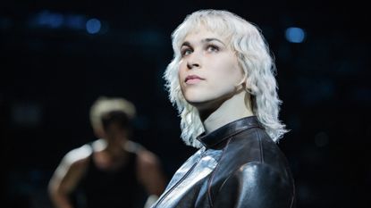 tommy dorfman starring as Tybalt in romeo and juliet on broadway wearing a leather jacket and white blonde hair 